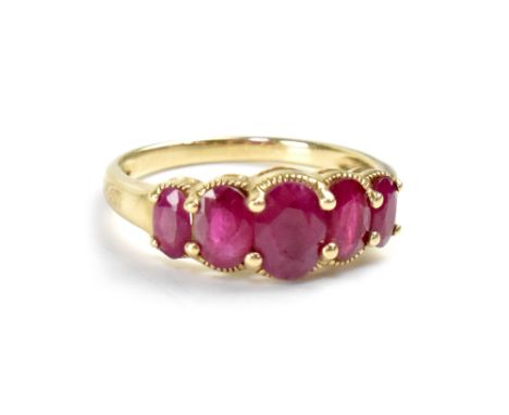 A yellow metal dress ring set with five graduated rubies, size P, approx 2.7g. CONDITION REPORT Stones with inclusions, other