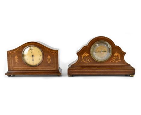 An Edwardian inlaid mahogany mantel clock, the dial set with Roman numerals within an arched top case with inlaid scroll moti