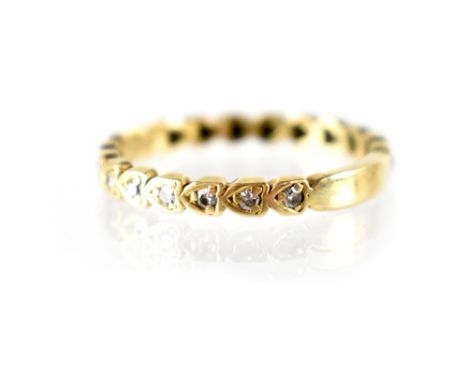 An 18ct gold and diamond full eternity ring, the Gypsy-set diamonds in heart-shaped mount, approx total 0.38ct, size W, appro