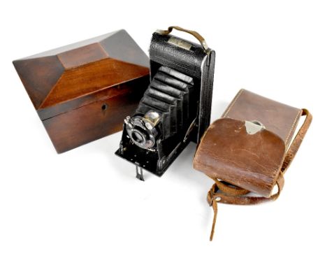 A 19th century mahogany sarcophagus tea caddy (lacking interior bowls), diameter 20cm, and a cased vintage Voigtlander camera