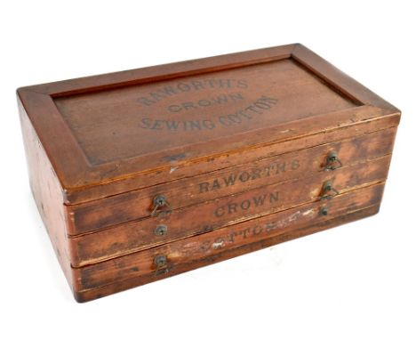 An early 20th century stained pine Raworth's Crown Sewing Cotton tabletop shop counter set of three drawers, marked to the to