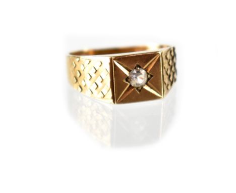 A 9ct yellow gold gentlemen's signet ring with starburst set white stone, size P, approx 2.9g.