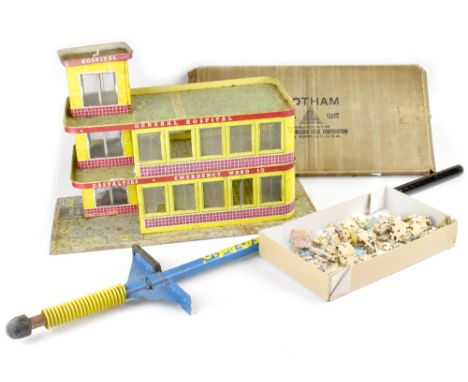 A vintage c1950s tin plate toy hospital building, vintage pogo stick, a box containing wooden puzzle pieces from two jigsaw p
