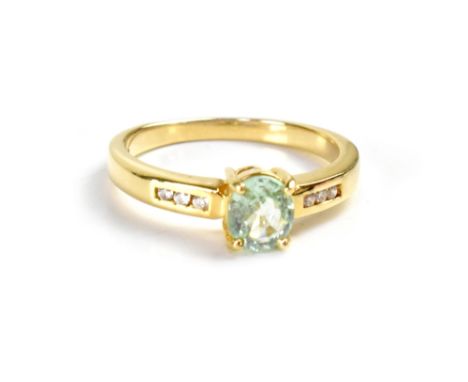 An 18ct yellow gold ladies' dress ring with oval aqua tourmaline and three small diamonds to either shoulder, size N, approx 