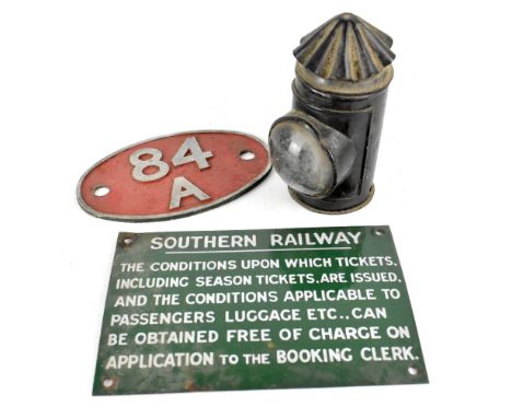 A green and white Southern Railway enamelled plaque referring to ticket conditions, also an 84A engine plaque and a black lac