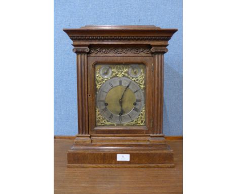 A late 19th Century carved oak bracket clock 