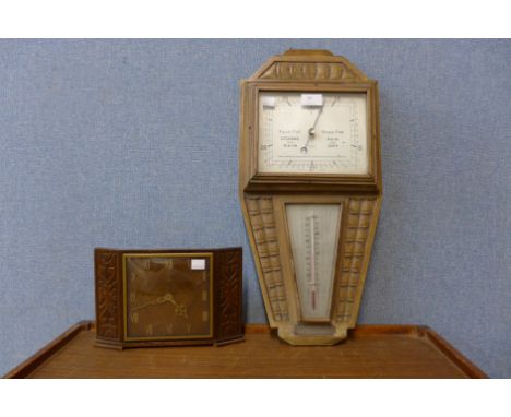 An Art Deco carved oak aneroid barometer and a Metamec timepiece 
