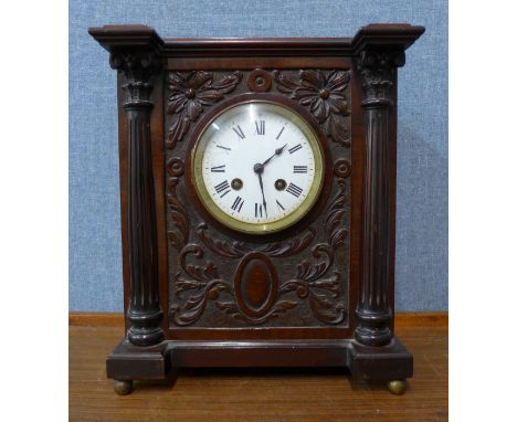 An early 20th Century French carved walnut mantel clock 