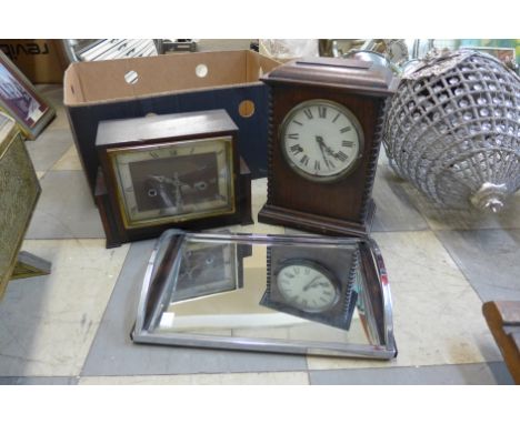 An Art Deco oak mantel clock, another mantel clock and a small chrome and mirrored tray 