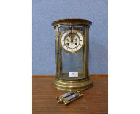 A 19th Century French oval brass and glass four sided mantel clock 