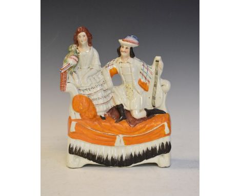 19th Century Staffordshire pottery figure group depicting a Scottish couple seated on a sofa   Condition: 