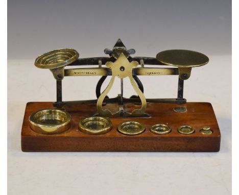 Set of vintage Mitchell's brass postage scales and weights on a mahogany plinth   Condition: 