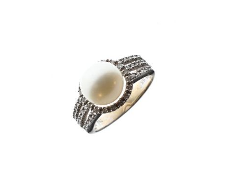 White metal ring set single pearl within a diamond surround and having conforming diamond set shoulders, the shank stamped 18