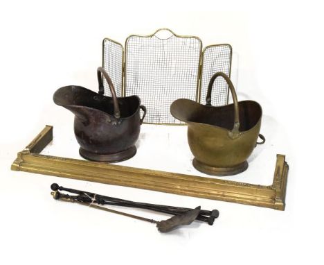 Copper coal helmet, brass coal helmet, brass fire kerb, fireguard and fire irons   Condition: 
