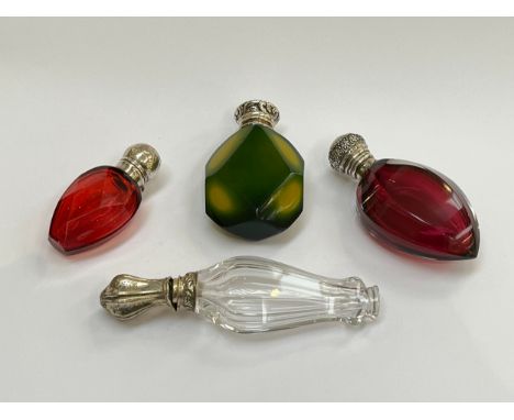 Four glass scent bottles including facet cut ruby, another in green and yellow, various makers and dates 