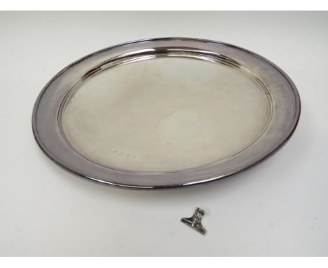 A John Bernard Stagg silver tray of plain form raised on three feet (one detached), Birmingham 1938, 35cm diameter, 1055g 