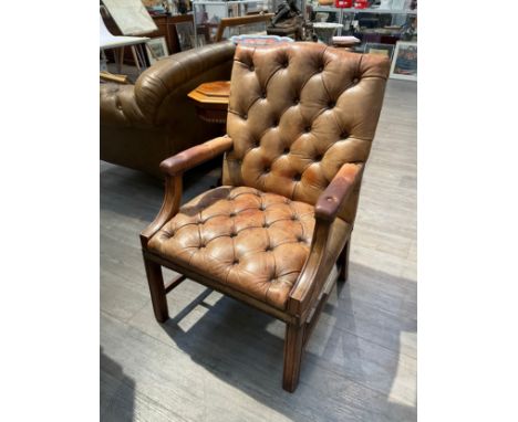 A leather Gainsborough style button back armchair 