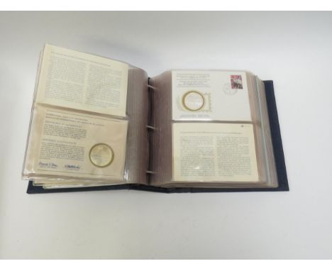 An album of International Society of Postmasters Official Commemorative Issue first day covers and sterling silver coins, 36 