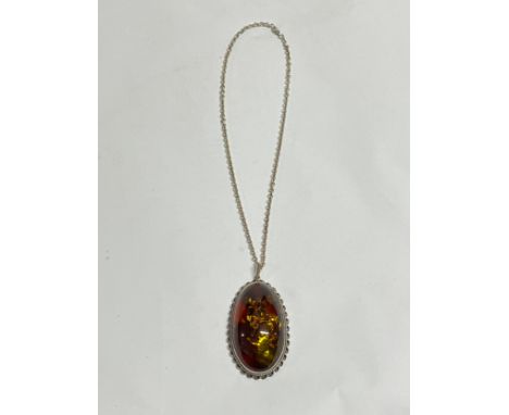 A modern large amber pendant on chain 