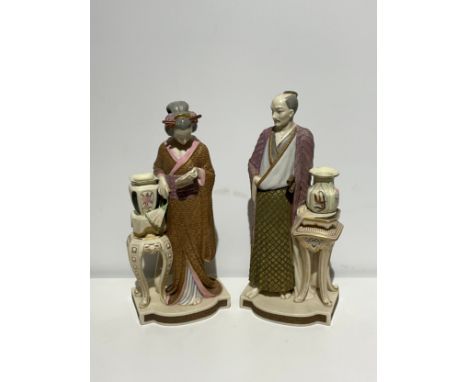 A large pair of Royal Worcester figures - a standing Japanese man and woman, designed by James Hadley, 42cm and 40cm tall 