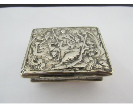 A 19th Century white metal snuff box, embossed figural scene, the lid opening to reveal spoon set to inner lid for snuff 