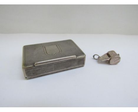 A white metal engine turned vesta with spring release lid and a "wolf whistle" charm 