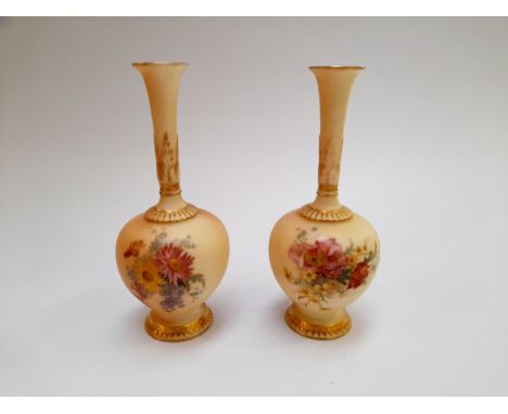 A pair of Royal Worcester peach ground bottle vases, 16.5cm tall 