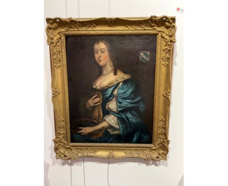 An 18th Century oil on canvas portrait of a young woman wearing a blue and white silk dress. Armorial crest to top right corn