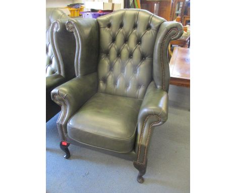 A reproduction green leather button wing back armchairLocation: 
