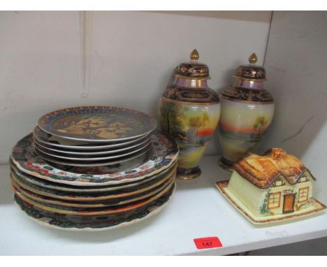 A pair of Noritake lidded vases, each decorated with a lake scene, trees and a cottage, 25h and other 19th century and later 