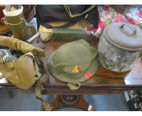 A British WWII army helmet for the 4th Battalion Middlesex Regiment with name inscription for F G Taylor, along with his gas 