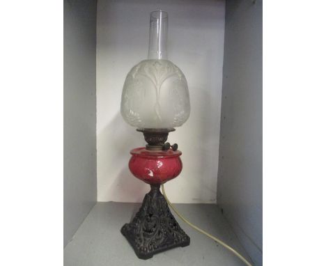 A Victorian converted oil lamp with frosted shade and ruby glass reservoir, 65cm hLocation: 