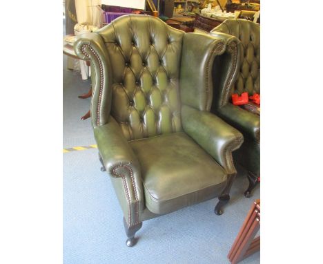 A reproduction green leather button wingback armchairLocation: 