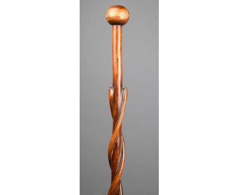 A Zulu / Tsonga staff South Africa wood, carved with two spiral snakes and with a spherical finial, 100.5cm long.