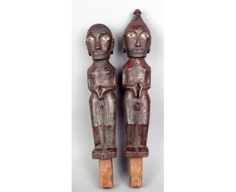 A pair of Batak male and female figures Indonesia wood, with inset bone eyes, 43cm and 47cm high. (2)