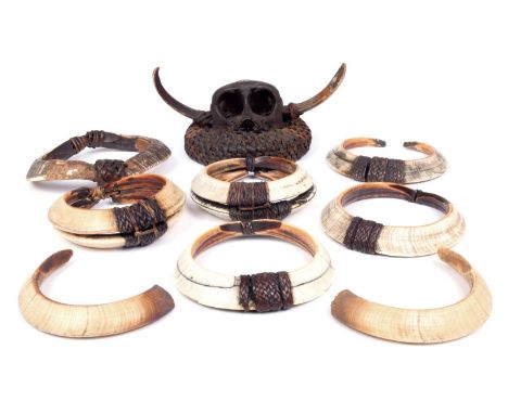 Five Northern Luzon tangkil Philippines rattan bound boar's tusks, 10.5cm - 14cm diameter, four other tusks and a monkey skul