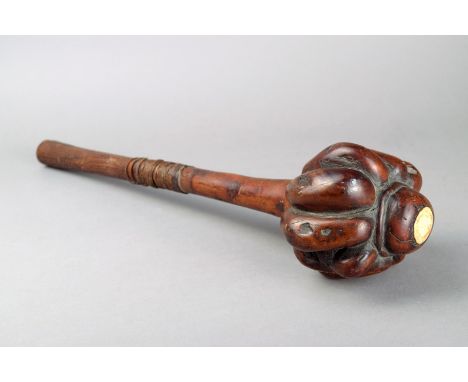A Fiji ula Melanesia wood, with a ribbed head and inset a bone disc in the lobed terminal, the shaft with binding and a carve