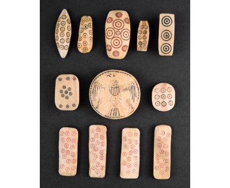 λ Twelve Inuit buttons marine ivory, mostly with punched circle and dot decoration, including a set of four with red staining