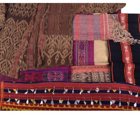 A Kalinga skirt Philippinnes with red, blue and yellow bands with bead and mother of pearl pendants, 107cm wide, two loin clo