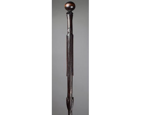 A South East African Chief's staff carved wood, with two spiral snakes and a stylised figure with long arms above a faceted k