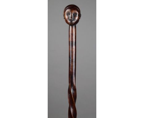 A Zulu staff South Africa wood, with a carved head finial and part spiralled shaft, with a label stating carved by John Zuma 