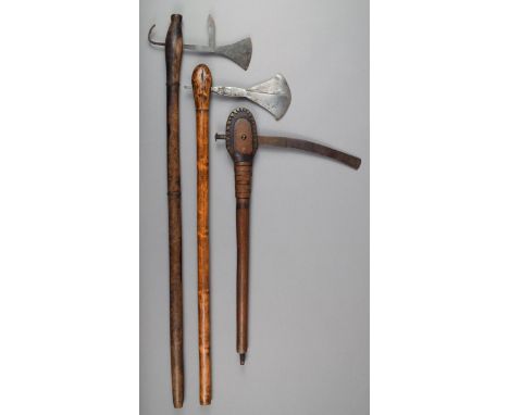 A Shona axe South Africa with a wooden shaft and shaped blade with incised decoration, 64.5cm long, a Shona axe, with a spurr