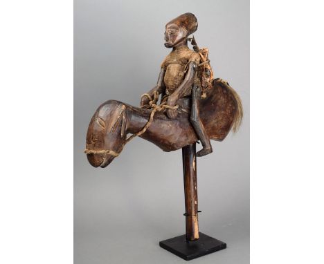 A Bozo equestrian puppet Mali wood, the horse with applied tail hair, the rider with articulated limbs and a cloth garment an