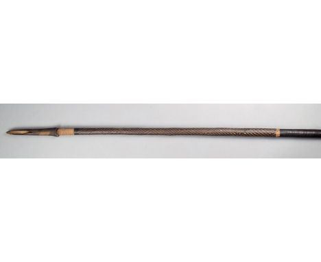 A Solomon Islands spear Melanesia wood, with a shaped bone point on a long wood shaft with patterned fibre binding to the top