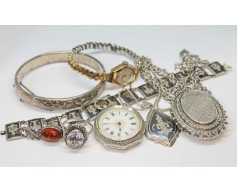 A mixed lot comprising a hallmarked silver bangle, a ladies 9ct gold watch with gold plated strap, a Victorian white metal lo