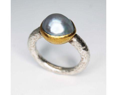 A contemporary silver ring by Poppy Dandiya, central bluish grey blister pearl set within a rub over gilt closed back spheric