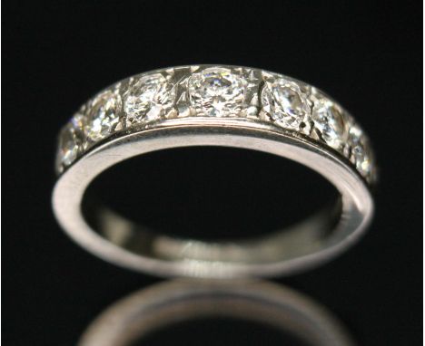 A seven stone diamond half hoop eternity ring, total approx. diamond wt. 1.10 carats, hallmarked 18ct white gold band, sponso