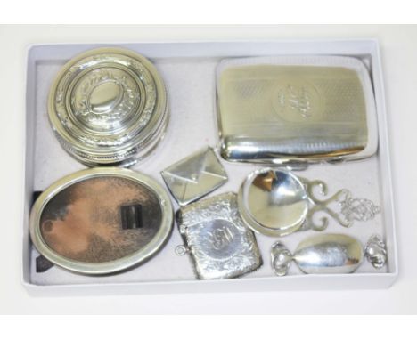 A tray of assorted hallmarked silver comprising a cigarette case, a stamp case, a vesta, a caddy spoon and a photo frame, tog