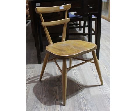 A vintage Ercol light beech and elm child's stacking chair with red dot to the back, height 64.5cm, width 42cm and depth 39.5
