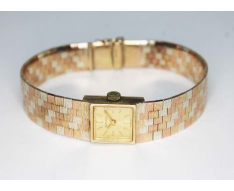 A ladies 9ct gold Bueche Girod wristwach, crica 1978, 17 jewel manual wind movement, textured three colour gold brick link br